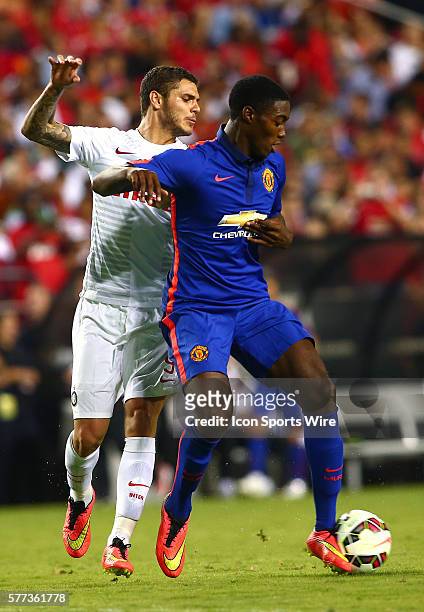 Tyler Blackett of Manchester United shields the ball from Mauro Icardi of Inter Milan during an International Champions Cup match at Fedex Field, in...