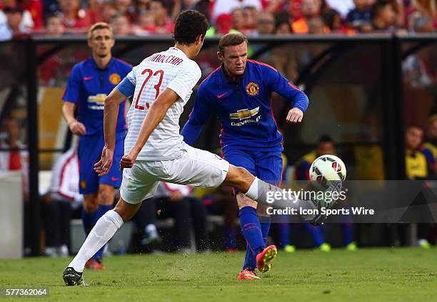 Wayne Rooney of Manchester United slots a pass past Andrea Ranocchia of Inter Milan during an International Champions Cup match at Fedex Field, in...