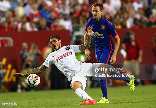 Jonny Evans of Manchester United tackles Mauro Icardi of Inter Milan during an International Champions Cup match at Fedex Field, in Landover,...