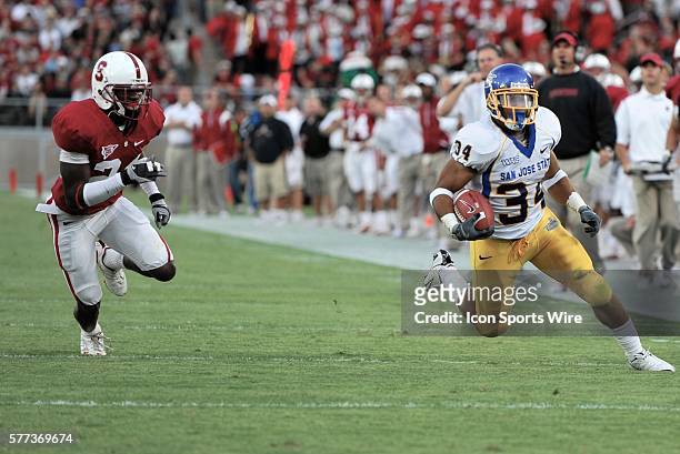San Jose State running back Yonus Davis heads up field as Stanford cornerback Kris Evans closes in for the tackle during the Cardinal's 23-10 victory...