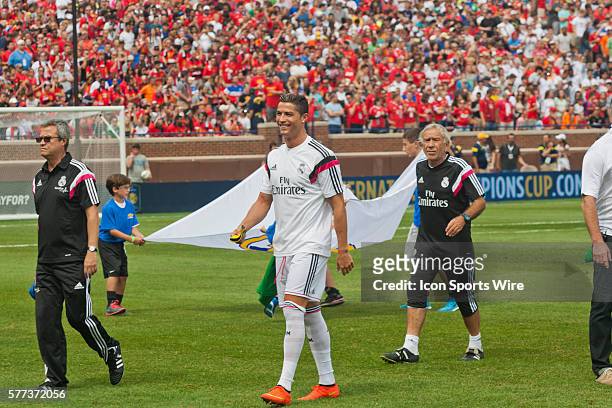 Real Madrid forward Cristiano Ronaldo smiles as fans cheer on his name as he walks to the bench before a Guinness International Champions Cup match...