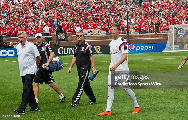 Real Madrid forward Cristiano Ronaldo, right, follows manager Carlo Ancelotti, left, to the bench behind before a Guinness International Champions...