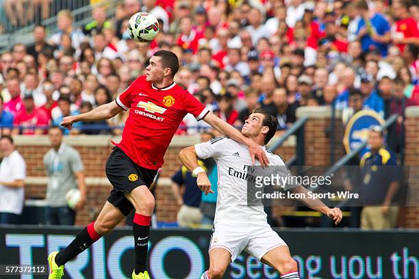 Manchester United defender Michael Keane, left, wins a header from Real Madrid forward Gareth Bale during a Guinness International Champions Cup...