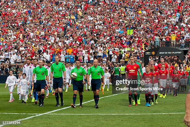 The game officials lead players out on to the pitch before a Guinness International Champions Cup match between Manchester United and Real Madrid, at...