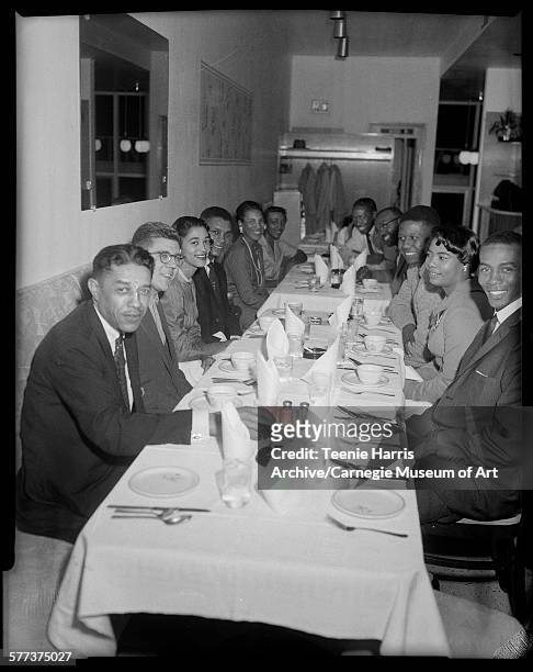 Group gathered around table in Stanley's, including on left: Mal Goode, George Kiseda, Ella Baker, Pittsburgh Pirates baseball player Gene Baker; on...