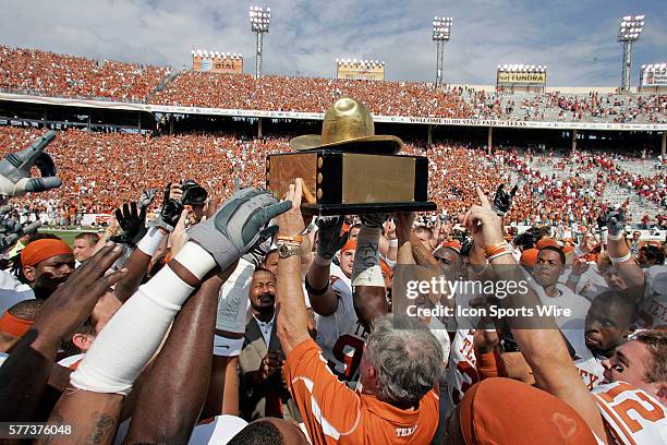 October 2008 - Coach Mack Brown of the Texas Longhorns holds up the Golden Hat trophy after the Texas 45-35 win over Oklahoma at the Red River...