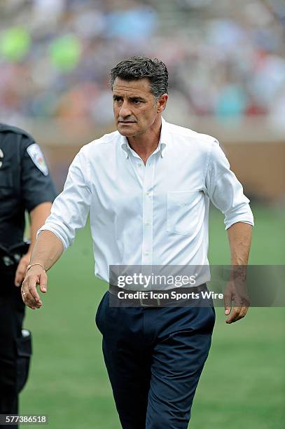 Olympiacos manager Michel walks off the field after defeating Manchester City F.C. During their soccer match during the 2014 Guinness International...