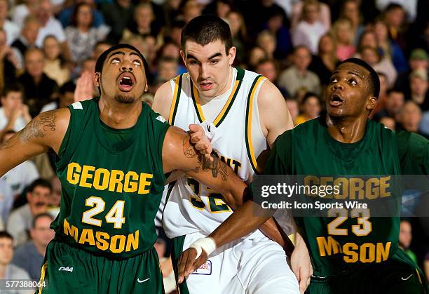 Catamounts forward evan Fjeld, a sophomore from Durham, North Carolina, fights with Patriots forward Ryan Pearson, a freshman from Far Rockaway, New...