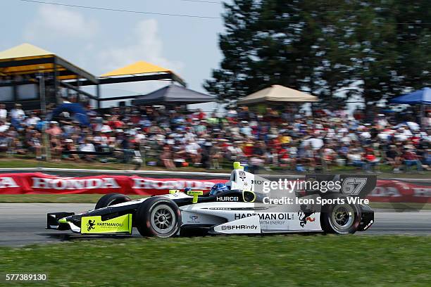 The fans watch IndyCar Driver Josef Newgarden in action during The Honda Indy 200 at the Mid-Ohio Sports Car Course in Lexington, OH