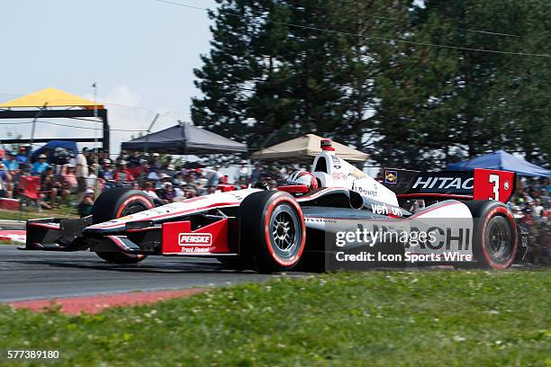 The fans watch IndyCar Driver Helio Castroneves in action during The Honda Indy 200 at the Mid-Ohio Sports Car Course in Lexington, OH