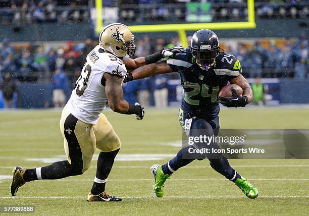 CenturyLink Field, Seattle, Washington: New Orleans Saints outside linebacker Ramon Humber tries to bring down Seattle Seahawks running back Marshawn...