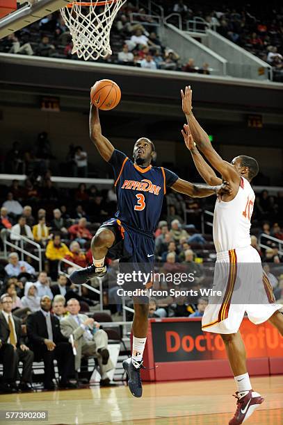 Pepperdine Keion Bell shoots past USC DeMar DeRozan during an NCAA basketball game between the Pepperdine Waves and University of Southern California...