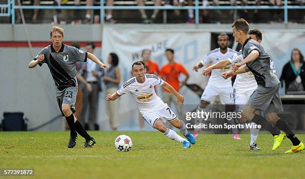 Swansea City AFC Swans midfielder Leon Britton carries the ball in front of Minnesota United Loons defender Greg Jordan during an international club...