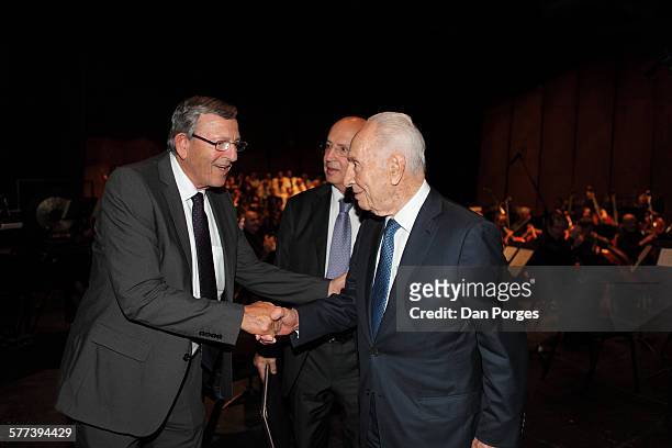 Director General of the Jerusalem Symphony Orchestra Yair Stern shakes hands with former Israeli President Shimon Peres during a Jerusalem Academy of...