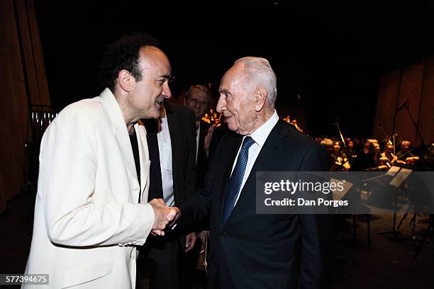 French conductor Frederic Chaslin shakes hands with former Israeli President Shimon Peres during a Jerusalem Academy of Music and Dance ceremony in...