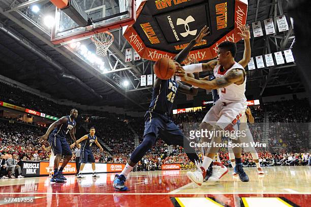 Maryland Terrapins guard Nick Faust makes a pass around Pittsburgh Panthers forward Talib Zanna at the Comcast Center in College Park, MD. Where the...