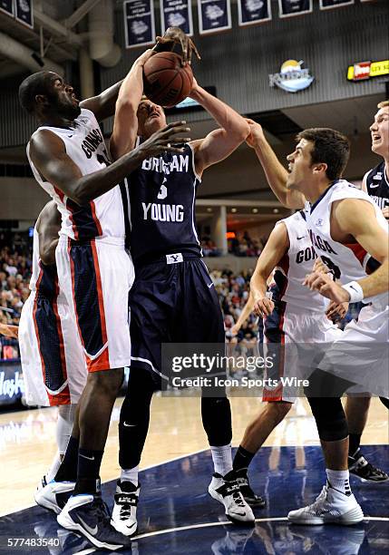 Sophomore guard Kyle Collinsworth tries to power up to score as Gonzaga senior center Sam Dower tries to block his shot during the WCC Conference...