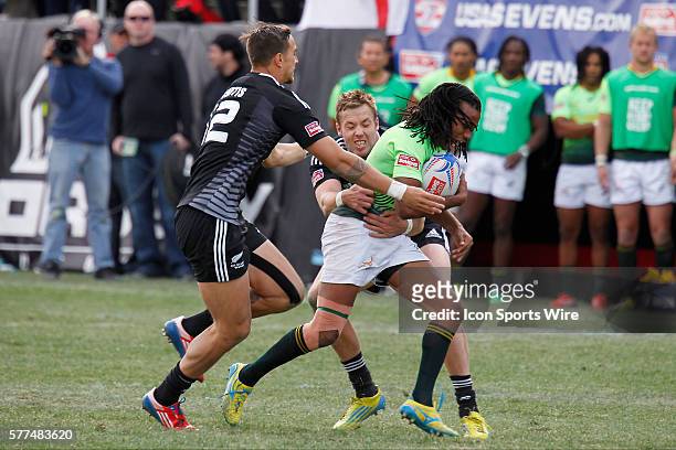 Cecil Afrika of South Africa tries to break a tackle during the Cup final on the last day of round 4 at the HSBC Sevens World Series of Rugby at Sam...