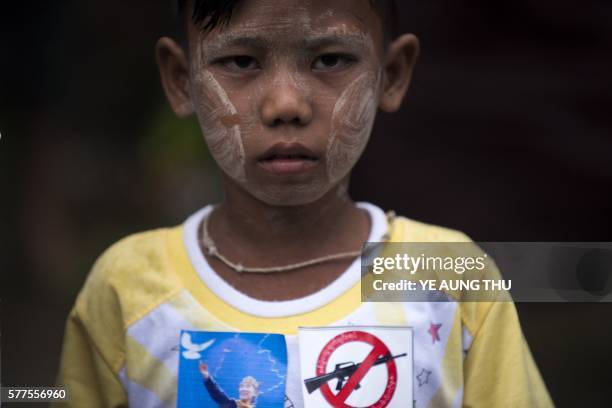 Boy wears traditional "thanaka" on his face as he attends a ceremony to mark the 69th anniversary of when Myanmar independence hero General Aung San...