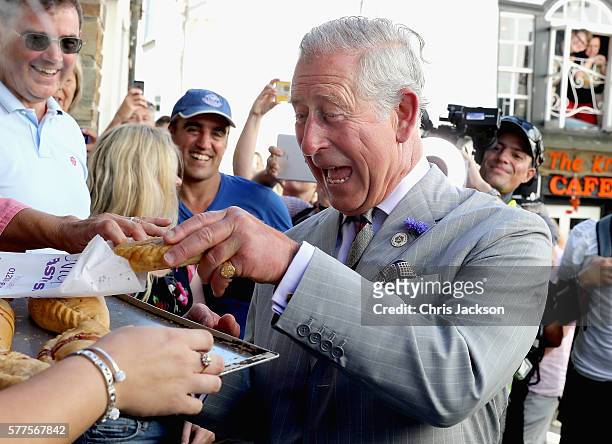 Prince Charles, Prince of Wales is given a Cornish Pasty as he visits Nicki's Bakery on July 19, 2016 in Port Isaac, England.