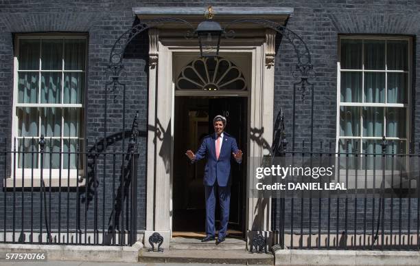 Secretary of State John Kerry gestures as he arrives for a meeting with new British Prime Minister Theresa May, at 10 Downing Street in central...