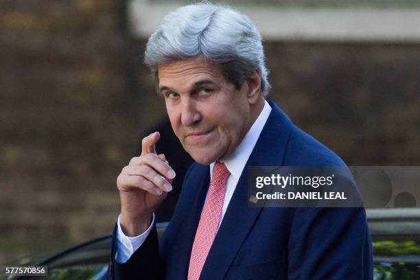 Secretary of State John Kerry gestures as he arrives for a meeting with new British Prime Minister Theresa May, at 10 Downing Street in central...