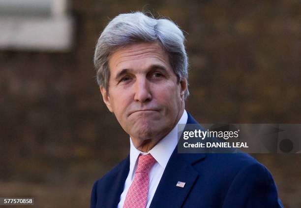 Secretary of State John Kerry gestures as he arrives for a meeting with new British Prime Minister Theresa May, at 10 Downing Street in central...