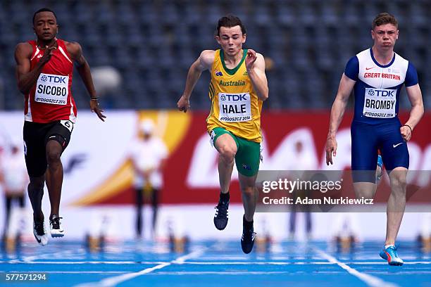 Dyland Sicobo from Seychelles and Jack Hale from Australia and Oliver Bromby from Great Britain compete in men's 100 meters qualification during the...