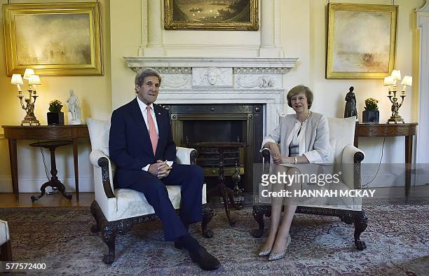 Secretary of State John Kerry and new British Prime Minister Theresa May pose for a photograph inside 10 Downing Street in central London on July 19...