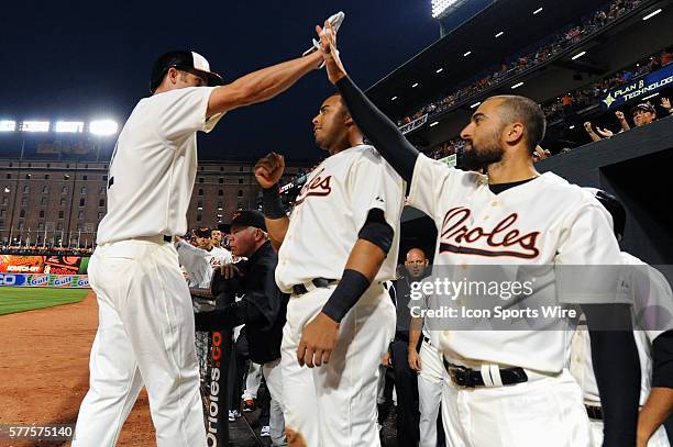 Baltimore Orioles third baseman Ryan Flaherty is congratulated by right fielder Nick Markakis after his home run against the St. Louis Cardinals at...