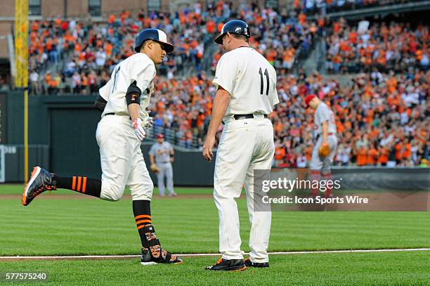 Baltimore Orioles third baseman Manny Machado is congratulated by third base coach Bobby Dickerson after his 3-run home run against the St. Louis...