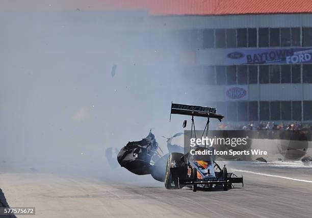 Urs Erbacher NHRA Top Fuel Dragster has a major mechanical problem causing the engine to explode against competitor Larry Dixon during the first...