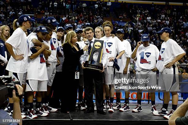 Connecticut Head Coach Geno Auriemma accepts the Championship trophy after the UConn Huskies 76-54 win over the Louisville Cardinals in the National...