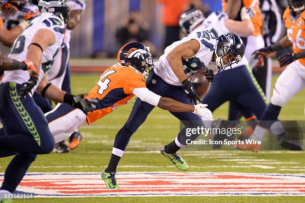 Seattle Seahawks wide receiver Doug Baldwin is tackled by Denver Broncos cornerback Champ Bailey during Super Bowl XLVIII between the Denver Broncos...