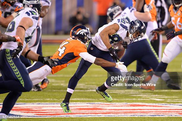 Seattle Seahawks wide receiver Doug Baldwin is tackled by Denver Broncos cornerback Champ Bailey during Super Bowl XLVIII between the Denver Broncos...