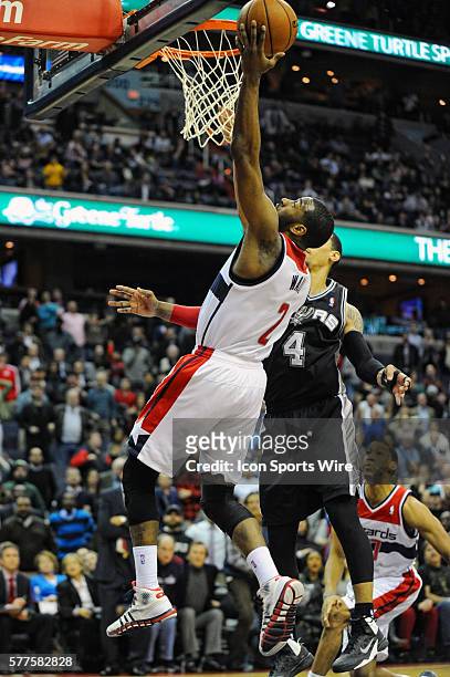 Washington Wizards point guard John Wall scores to send the game into double overtime against San Antonio Spurs shooting guard Danny Green at the...