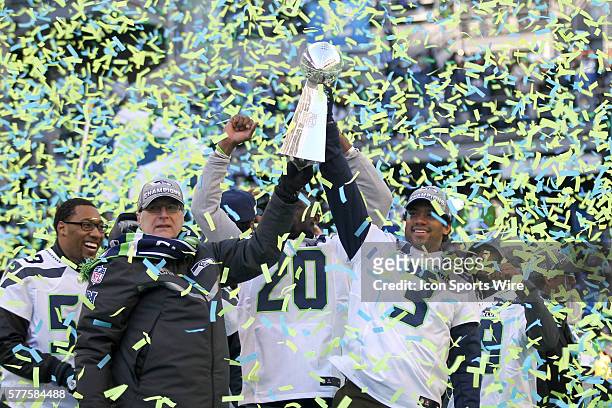 Seattle Seahawks owner Paul Allen and quarterback Russell Wilson hoisted the Super Bowl trophy up in the air together. Seattle Seahawks players and...