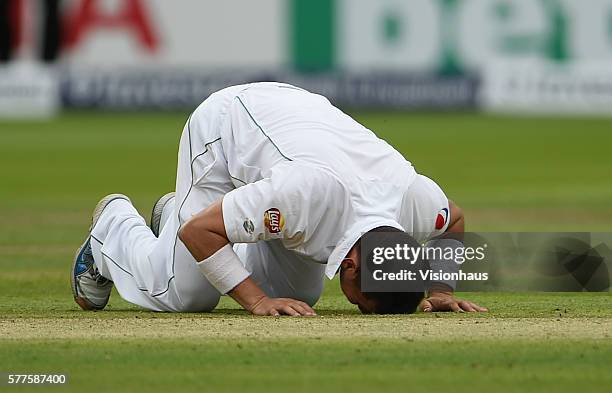 Yasir Shah of Pakistan celebrates taking five wickets by kissing the pitch during day two of the first Investec test match between England and...