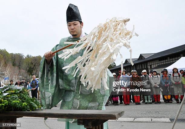 Hinoemata, Japan - A Shinto priest prays for the safety of visitors during a ceremony to mark the beginning of the climbing season in the Oze...