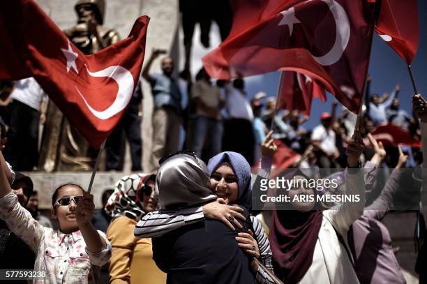 Pro-Erdogan supporters react during a protest at the Sarchane park in Istanbul on July 19, 2016. The Turkish army said on July 19 that the vast...