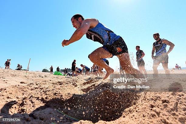 Haydn Thomas of Exeter Chiefs sprints up a sand dune during a training session on Exmouth Beach on July 19, 2016 in Exmouth, England.