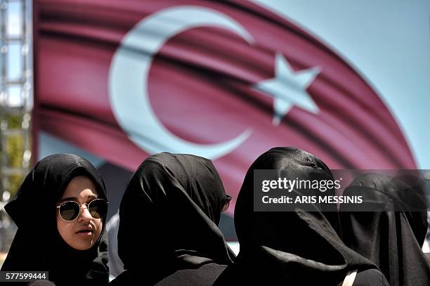 Woman looks on during a demonstration in support of Turkey's President Erdogan at the Sarachane park in Istanbul on July 19, 2016. Turkey has...