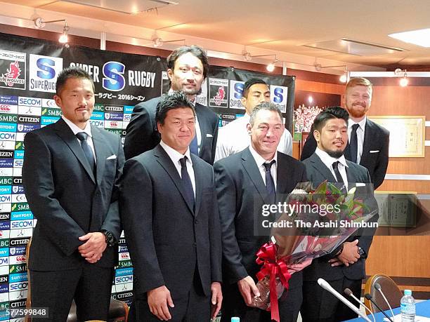 Head coach Mark Hammett and players of the Suwolves pose for photographs during a press conference after their first season in the Super Rugby on...