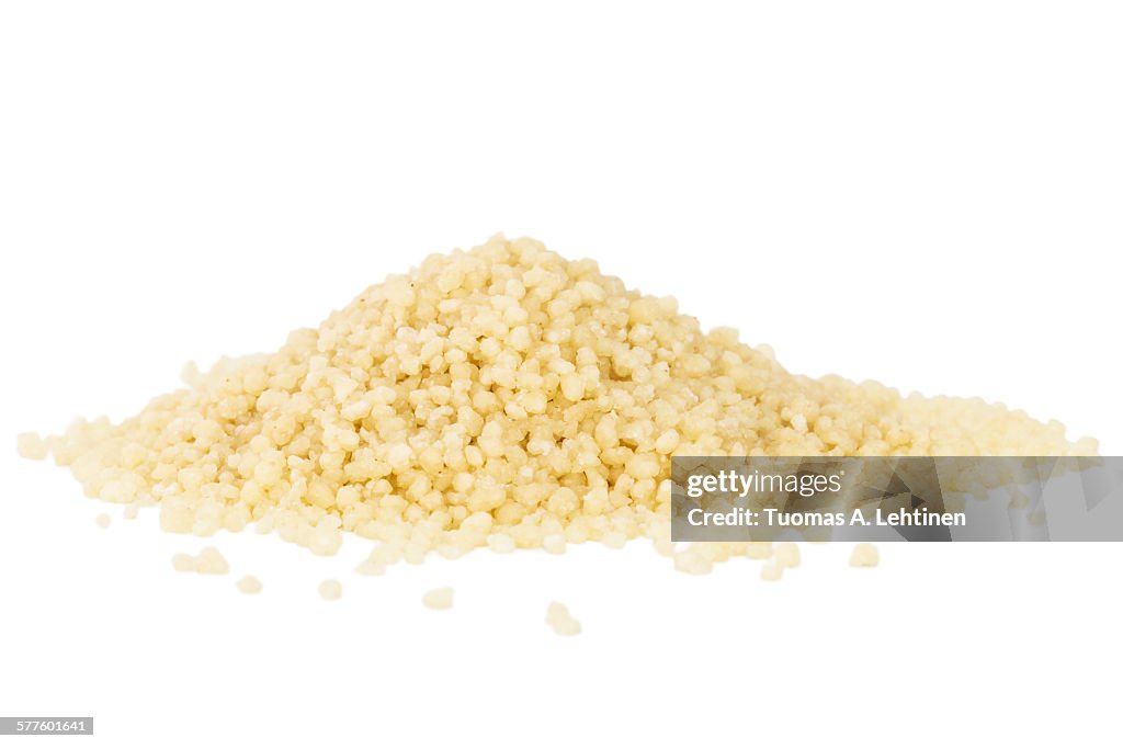 Heap of couscous isolated on white background