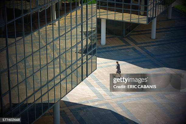 Man walks past a building in central Toulouse on July 19, 2016. / AFP / ERIC CABANIS