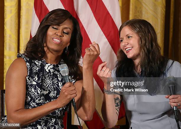 First lady Michelle Obama snaps her fingers with college student Rachel Scott at an event with future college students in the East Room at the White...