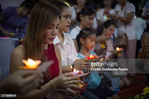 Buddhists devotees light candles at Wat Pathum Temple to celebrate Asana Bucha Day know as Buddhist Day. The day is observed on the full moon of the...