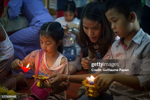 Buddhists devotees light candles at Wat Pathum Temple to celebrate Asana Bucha Day know as Buddhist Day. The day is observed on the full moon of the...