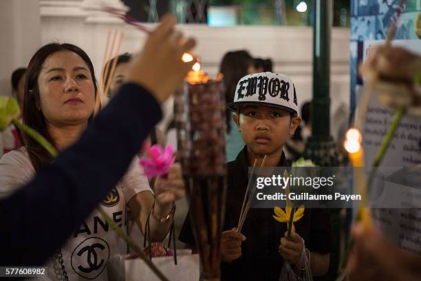 Buddhists devotees light incense at Wat Pathum Temple to celebrate Asana Bucha Day know as Buddhist Day. The day is observed on the full moon of the...