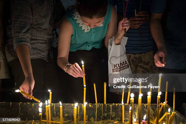 Buddhists devotees light candles at Wat Pathum Temple to celebrate Asana Bucha Day know as Buddhist Day. The day is observed on the full moon of the...